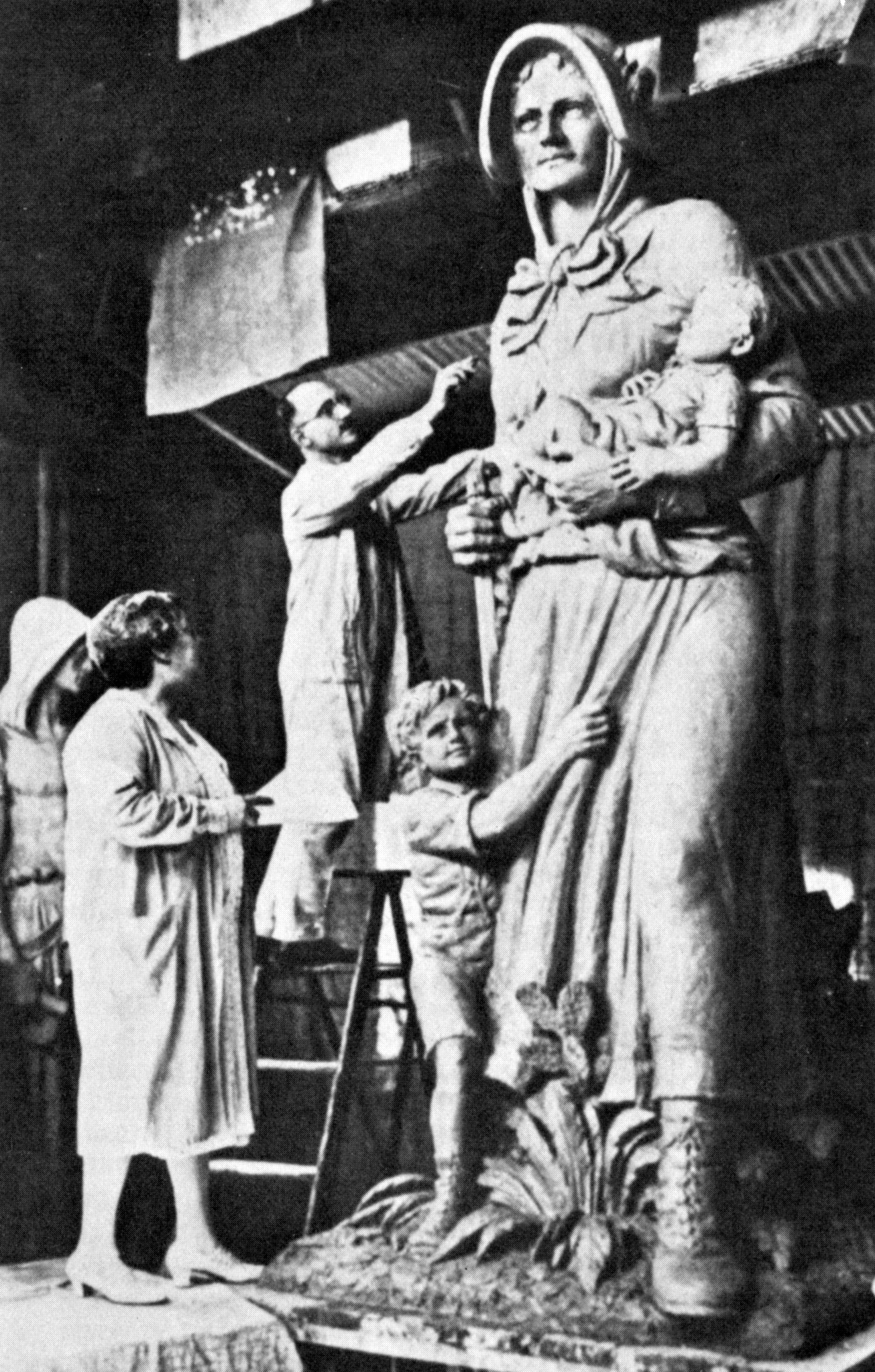 This photograph showing sculptor August Leimbach at work on the Madonna of the Trail statue was widely reprinted in newspapers and magazines during and after dedication of the 12 monuments. Mrs. Arline B. Moss looks on.