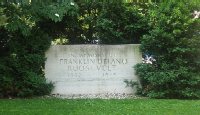 For many years, this marble block, sitting on the west corner of the National Archives grounds, was the only memorial to Franklin Delano Roosevelt, President of the United States from 1933 to 1945.  A more fitting memorial was dedicated on May 2, 1997.  The expansive, multi-chambered Franklin Delano Roosevelt Memorial is located along the Cherry Tree Walk on the western edge of the Tidal Basin near the Jefferson Memorial.