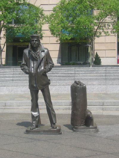 This life-size statue of a young sailor is part of the U.S. Navy Memorial on the north side of Pennsylvania Avenue between 7th and 9th Streets. The waterfall that lines the memorial was not in operation on the day this photograph was taken.